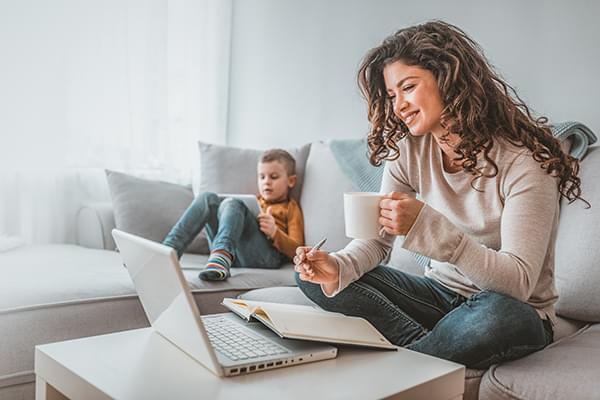 Smiling woman looking at laptop